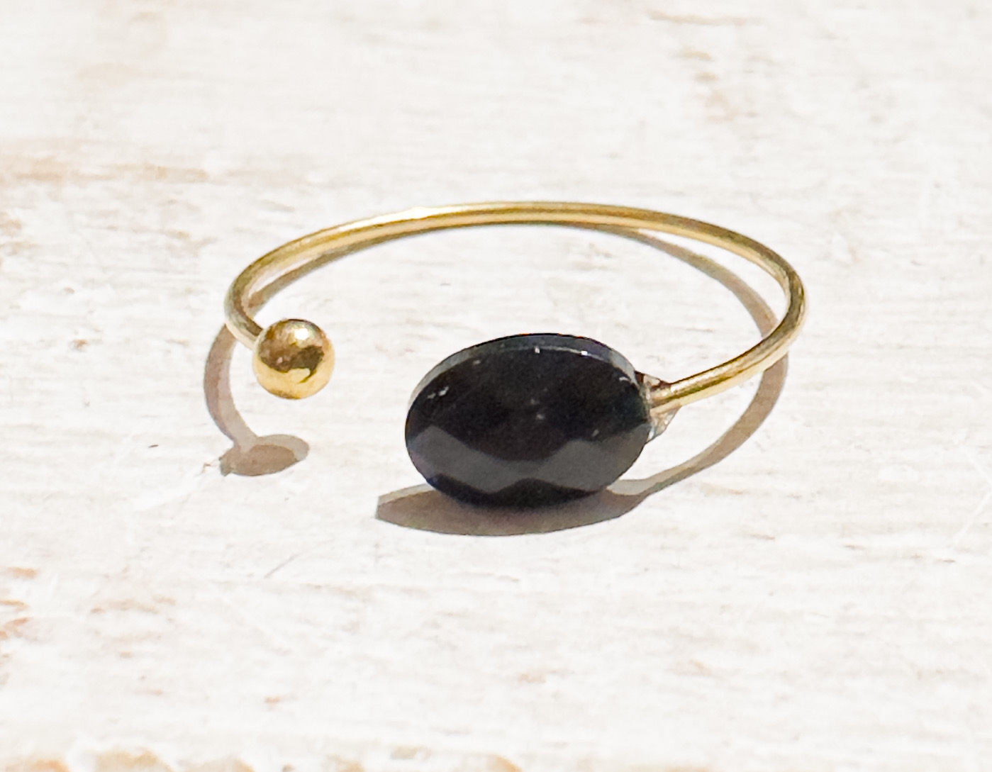Anillo abierto piedra negra acero dorado