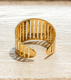 Anillo acero dorado barrotes