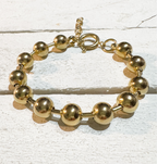 Pulsera acero dorado bolas