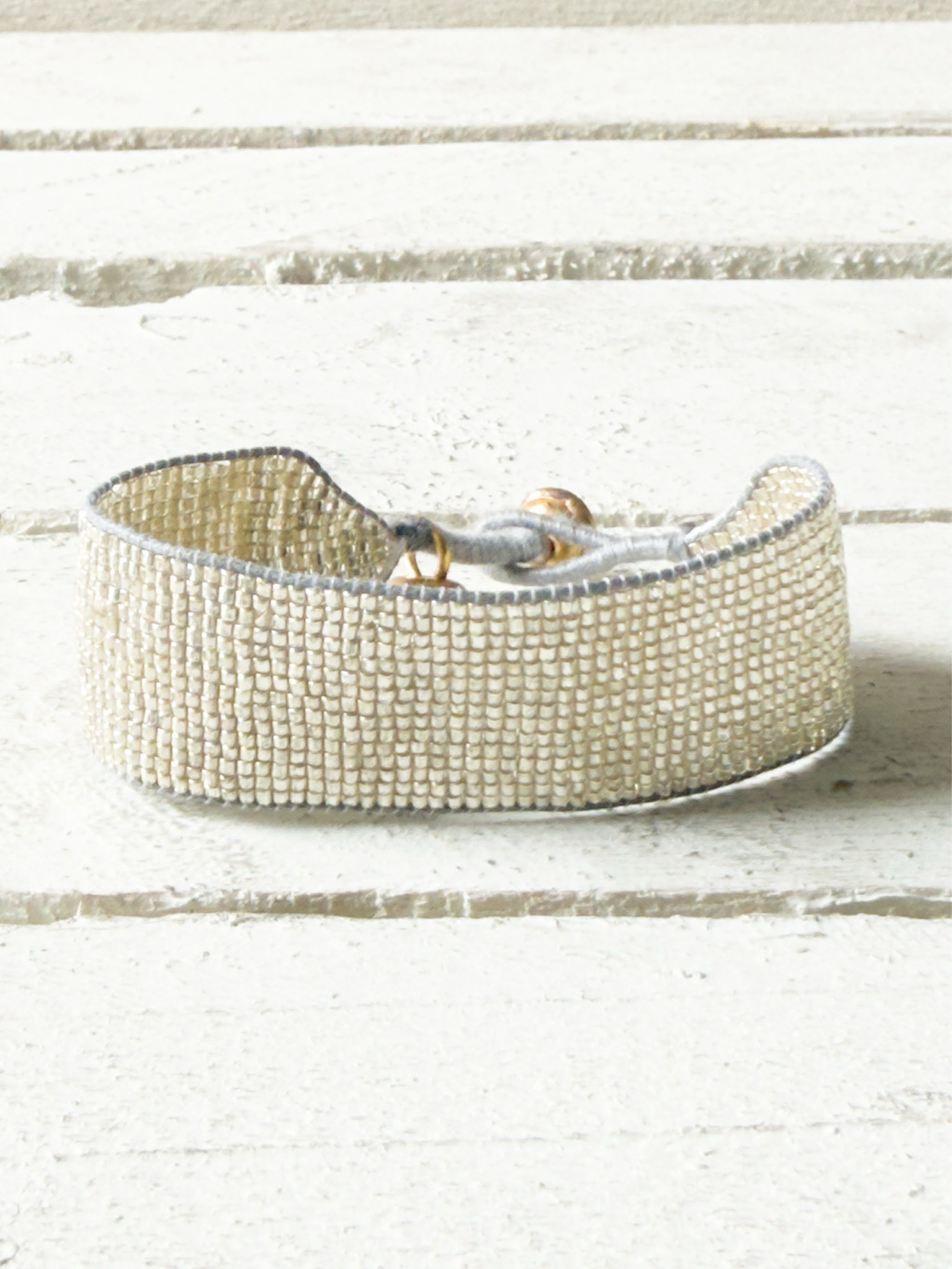 Pulsera miyuki cristales plata cuerda gris cascabel 2cm