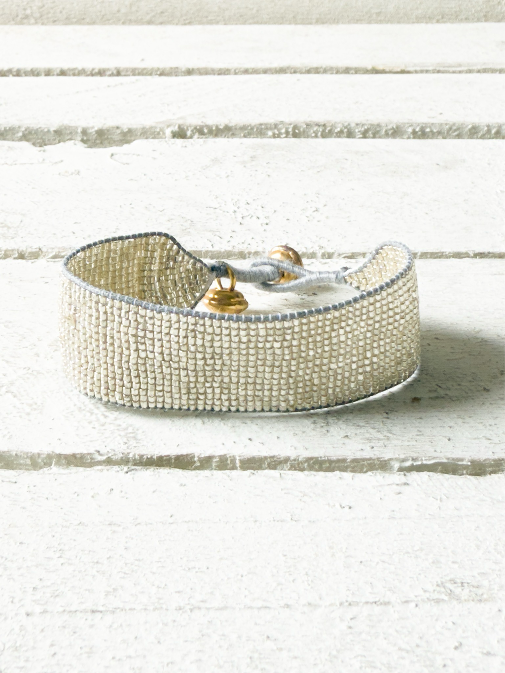 Pulsera miyuki cristales plata cuerda gris cascabel 2cm
