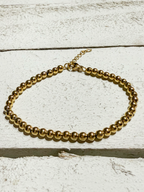 Pulsera bolitas doradas acero