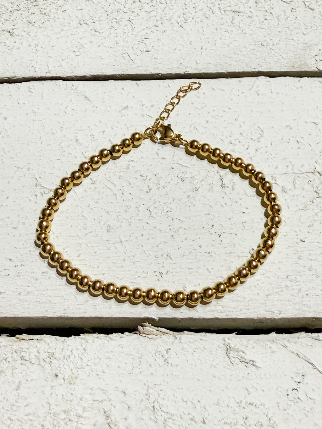 Pulsera bolitas doradas acero