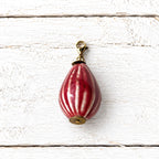 Charm peonza cerámica rojo