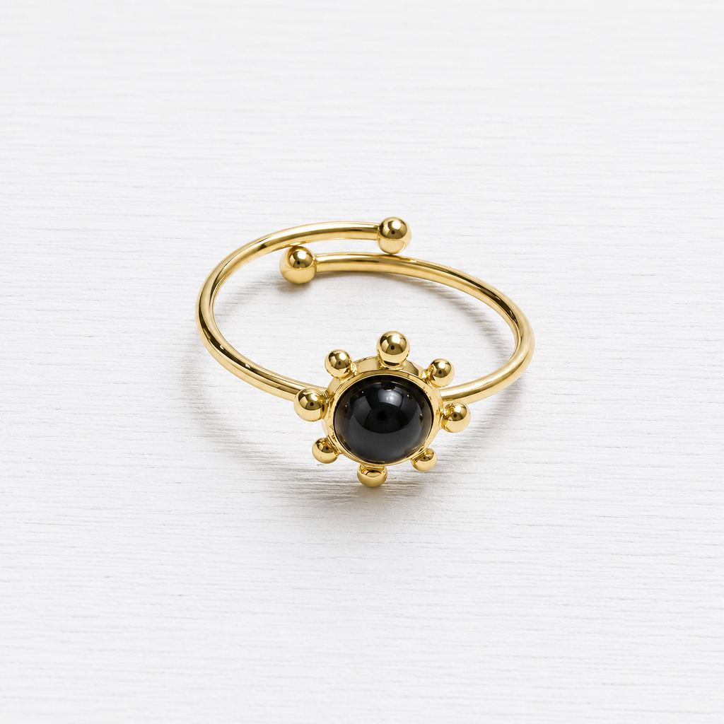 Anillo acero dorado sol piedra negra