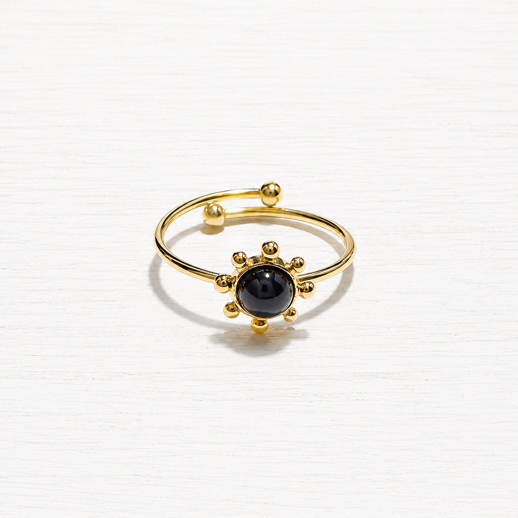 Anillo acero dorado sol piedra negra